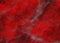 Mist of grey on bright red marbled brush strokes pattern with light drips on black background