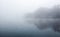 Mist hovering over a cold lake in Goldsworth Park, Surrey, Woking, England