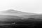 Mist and smoke between valley and layers of mountains and hills at dusk, in Umbria Italy