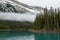 A mist and turquoise water of the Maligne lake, Alberta, Canada