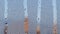 Misted glass of window with water condensate. Drops are falling down. Blurred buildings at the background.