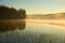 Misty august morning on forest lake, Finland