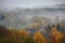 misty autumn morning, with quiet village surrounded by misty forest