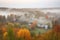 misty autumn morning, with quiet village surrounded by misty forest