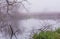 Misty, calm morning at a river in Scania, Sweden. Reflections in the water