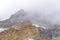 Misty clouds over the rugged peak of rocky mountain in Provo Canyon Utah