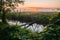 Misty dawn on the banks of a small river with a bridge.