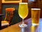 Misty glasses with two pints of cold Scotch ale, amber pale ale, lager draft beer in English pub