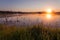 Misty Golden Sunrise Reflecting over Lake in Spring