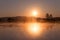 Misty Golden Sunrise Reflecting over Lake in Spring