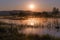 Misty Golden Sunrise Reflecting over Lake in Spring