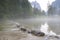 Misty Italian lake flowing through rocks.