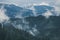 Misty landscape of mountain and forest. Summer foggy and cloudy morning