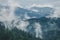 Misty landscape of mountain and forest. Summer foggy and cloudy morning