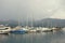 Misty Mediterranean landscape. Yachts in the fog. Montenegro, Bay of Kotor, Tivat city, view of yacht marina of Porto Montenegro