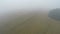 Misty morning agriculture crop field, aerial view
