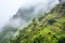 misty morning with inca terrace ruins on a steep hillside