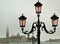 Misty morning looking at Typical venetian street lamps and over to the Redentore, Venice 