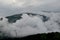 Misty morning at mountains covered under clouds