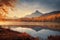 Misty morning over alpine forest and lake