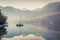 Misty morning scene on Grundlsee lake with yacht.