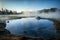 misty morning at a serene geothermal lake
