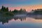 Misty morning on a small lake. Atmospheric sunrise