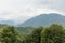 Misty mountain landscape with fir forest. Beautiful landscape with mountain view, cable car.