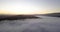 Misty mountain Valley filled with fog clouds during sunrise with golden gradient sky