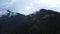 Misty mountain wood from bird-eye Aerial view. Lush clouds cover wild foggy mountain