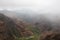 A misty rain falling over Waimea Canyon on a cloudy day at Puka Pele Lookout in Waimea Canyon State Park