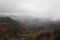 A misty rain falling over Waimea Canyon on a cloudy day in Waimea Canyon State Park, Kauai