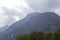 Misty ridge in Trento. Hillside in the Fog. The clounds cover the blue montains.