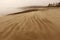 A misty, sandy and desolate beach