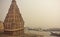 Misty scene of Ganges riverbank and sacred flooded Shiva temple in Varanasi