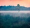 Misty summer sunset on Ukrainian countryside. Picturesque evening scene of Shatsky National Park,