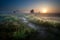 Misty sunrise over countryside path