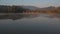 Misty sunrise over lake at alpine countryside.