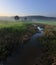 Misty sunrise with small stream