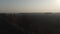 Misty sunset over agricultural field on countryside. Aerial drone view of dark landscape in rural area. Majesty of