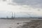 Misty view from across the water on Poolberg peninsula, with the chimneys of the power generation station , view from the beach