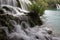 Misty waterfalls flowing into lake