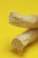 Miswak natural toothbrush close-up on a bright yellow background.Dental hygiene.