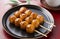 Mitarashi dango and green tea on a red Japanese tray