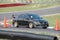 Mitsubishi Evolution Sedan driving on Race Course