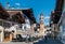 MITTENWALD, GERMANY - View of famous Painted Buildings and Church Tower in the historic Center of Mittenwald in Bavaria with peopl