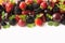 Mix berries and fruits on white background. Ripe blackberries, strawberries, blackcurrants and plums. Top view.