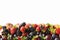 Mix berries and fruits on white background. Ripe blackberries, strawberries, blackcurrants and plums. Top view. Background berries