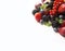 Mix berries on a white background. Ripe blueberries, blackberries, red currants, strawberries, black currant and plums. Various fr