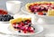 Mix berry tart, pie, cake with raspberries, bilberries, bluberries, red currant and cream